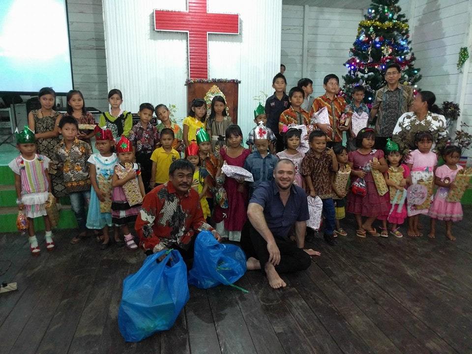 A pastor with his congregation at a mission church