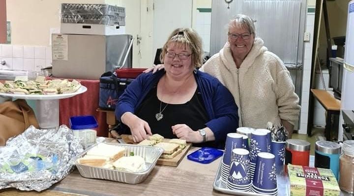 Two ladies preparing food and coffee at Calvary