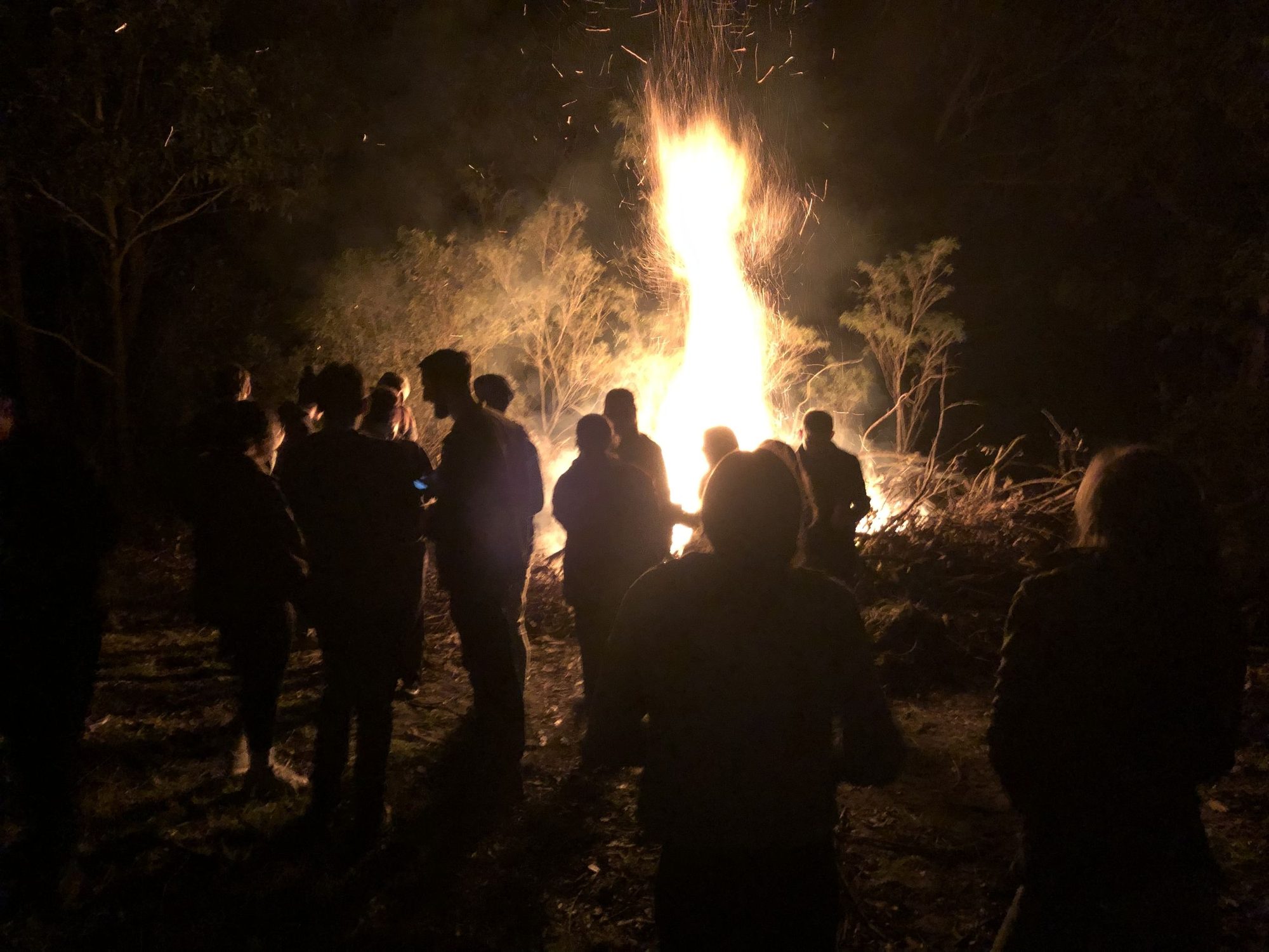 Youth around a bonfire at night