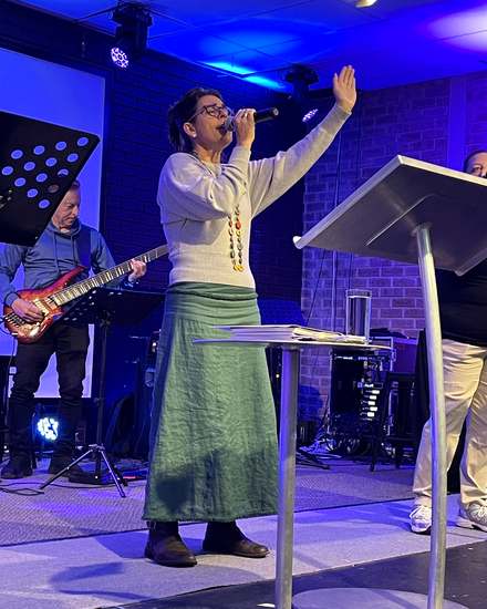 A worship leader singing at Calvary